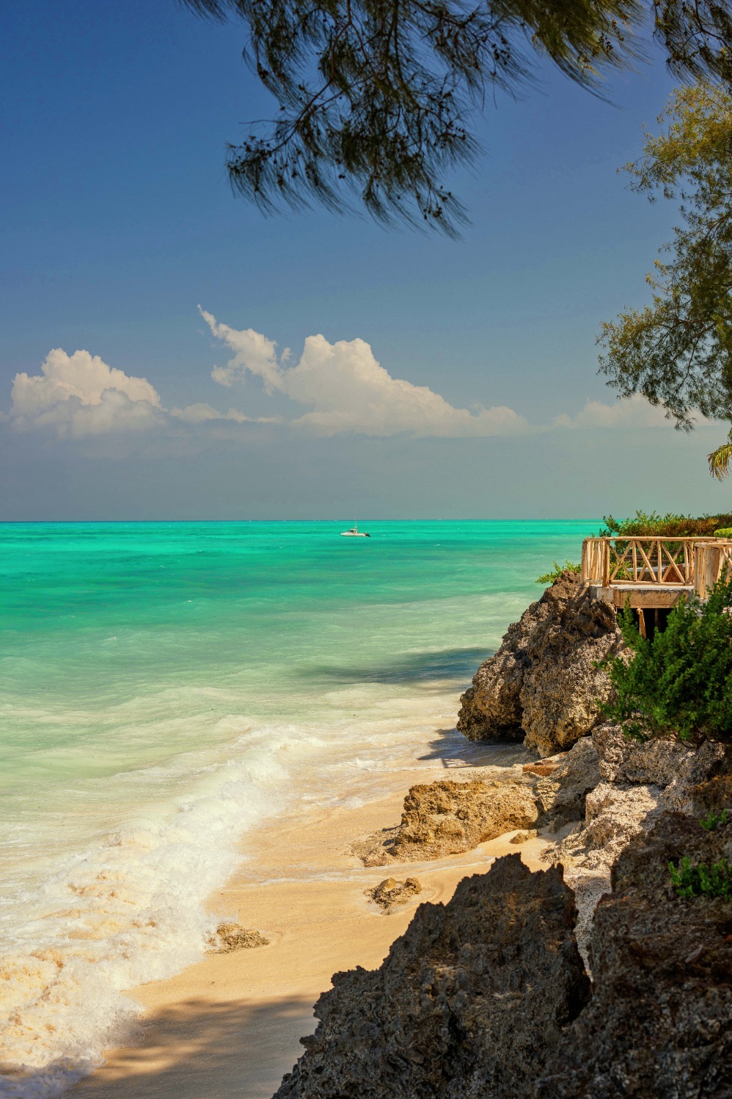 Turquoise sea breaking over the rocks and sand