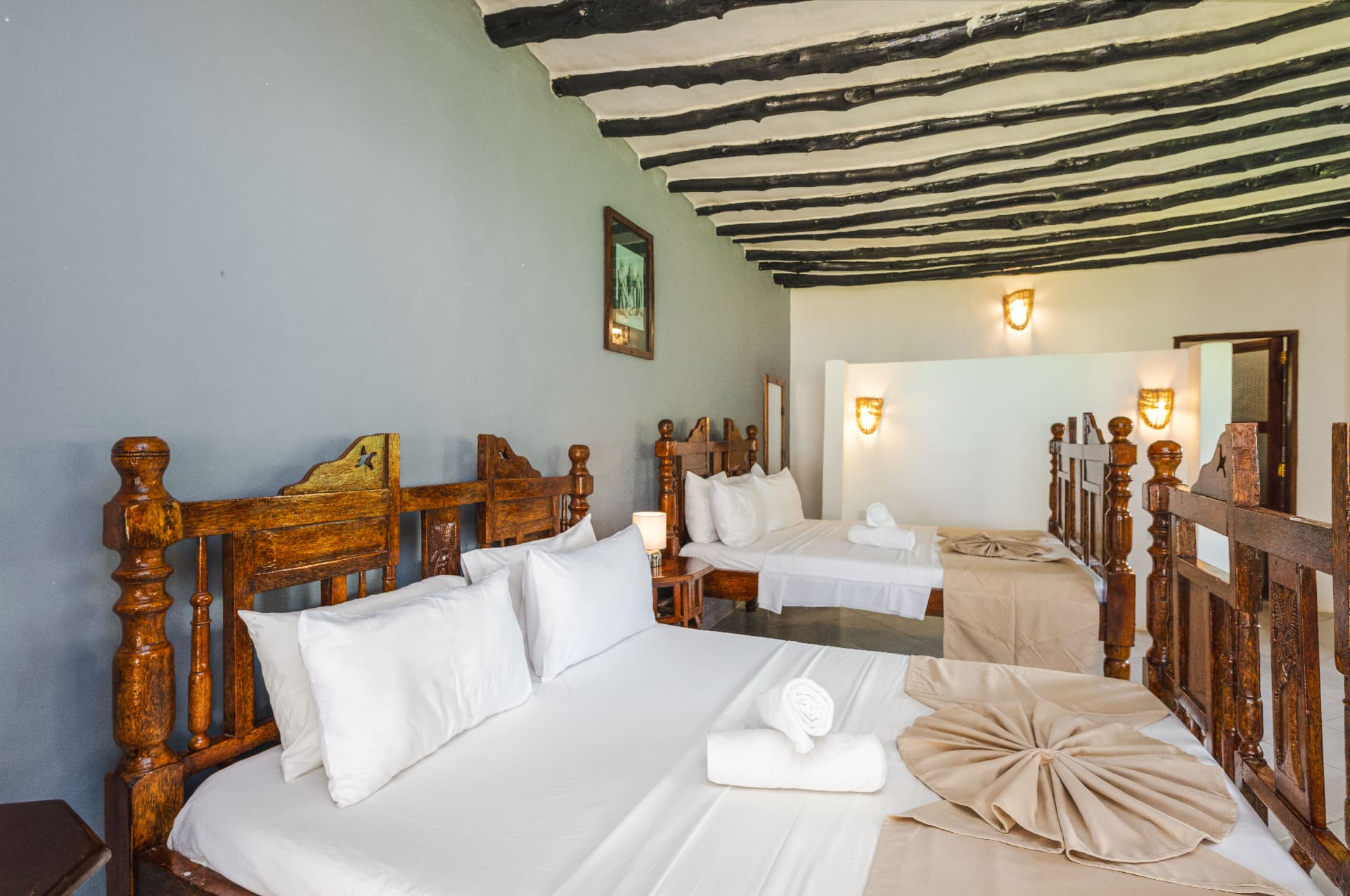 Family room with two carved wood beds